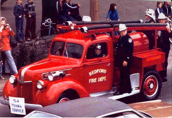 Colour photo of firefighters riding vehicle