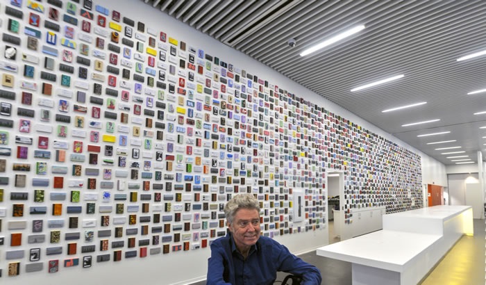 A photo of the artist and the artwork for the Halifax Central Library at the time of its installation.