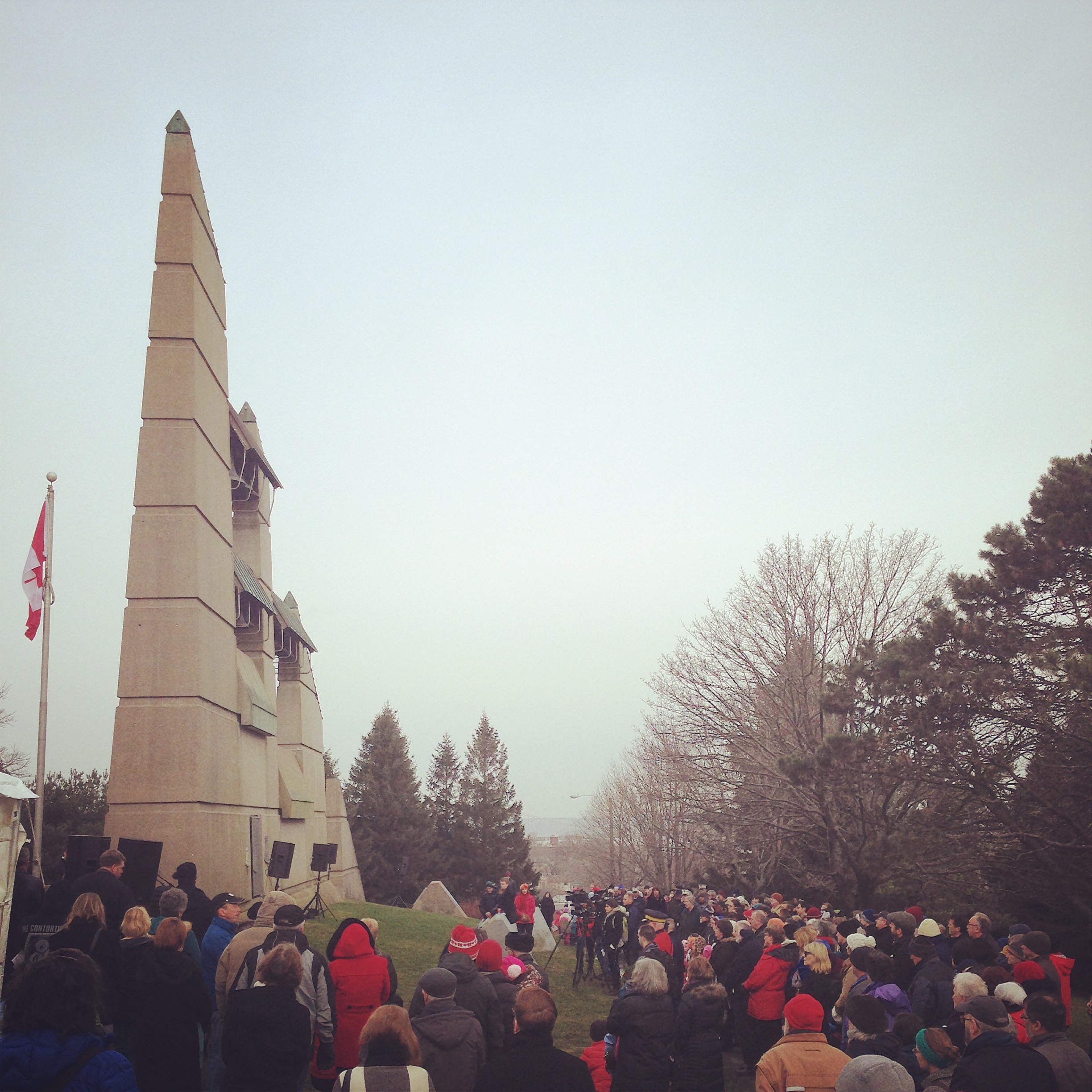 A photo of the Halifax Explosion Memorial Service at Fort Needham Park, with Memorial Bell Tower in the background