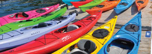 Colourful Kayaks lined up in a row