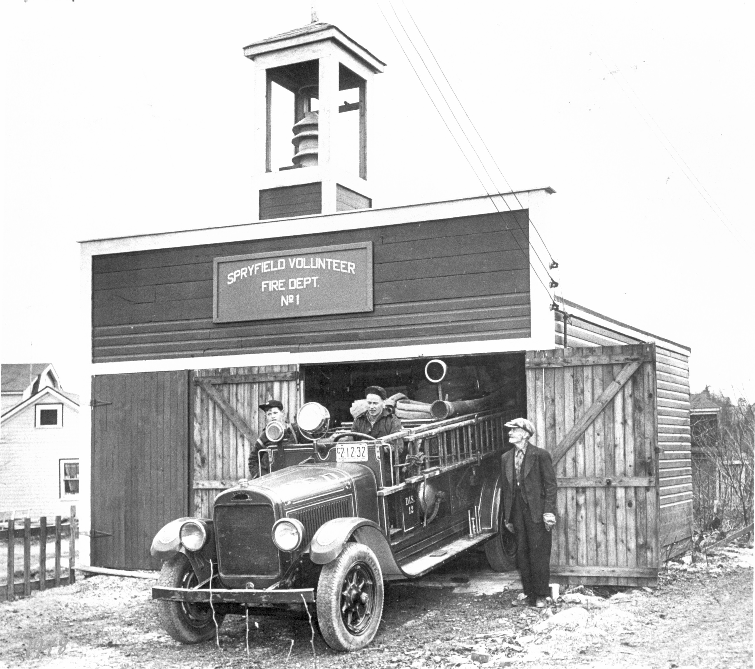 Black and white photo of a fire vehicle. 