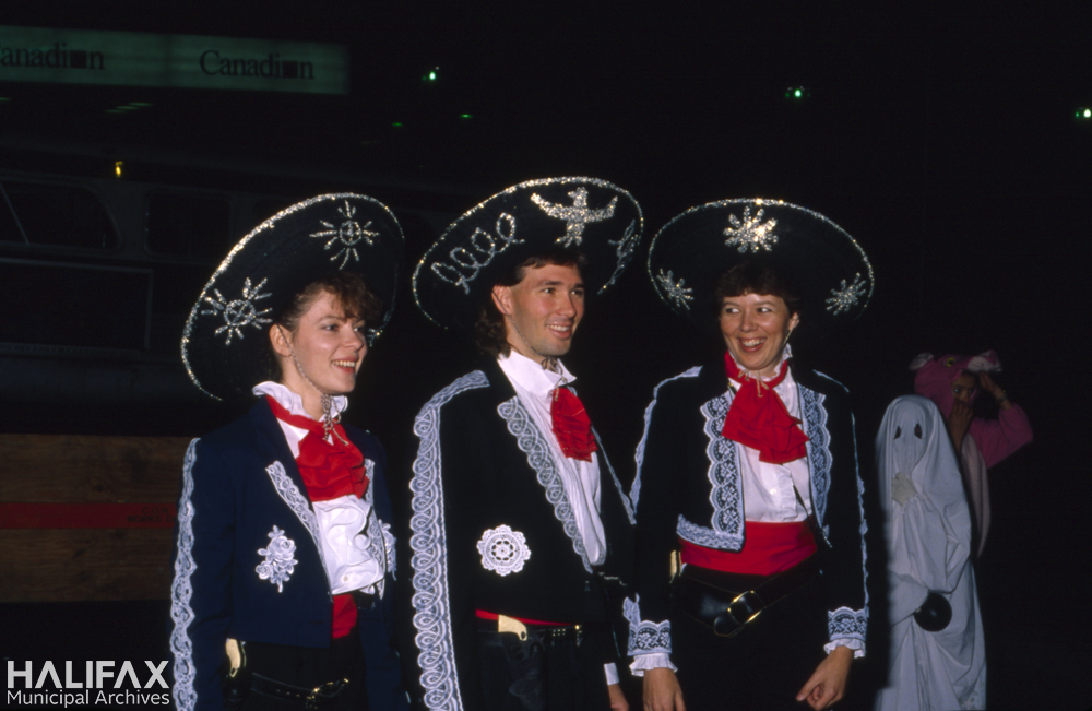 Colour photo of three participants dressed in Mexican mariachi costumes