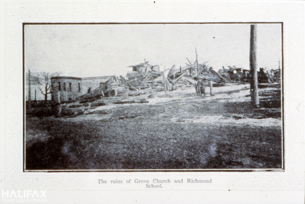 Black and white photograph of ruined church and school.