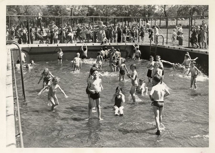 Black and white photo of locals in a swimming pool