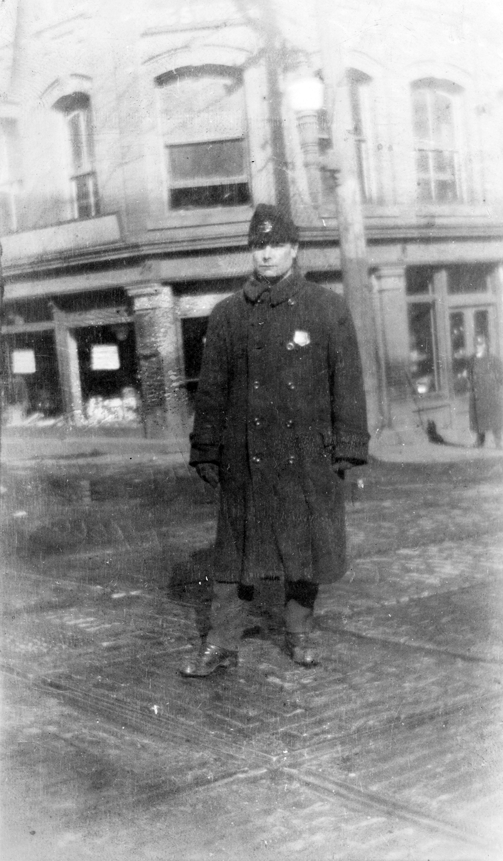 Black and white photo of officer standing in street