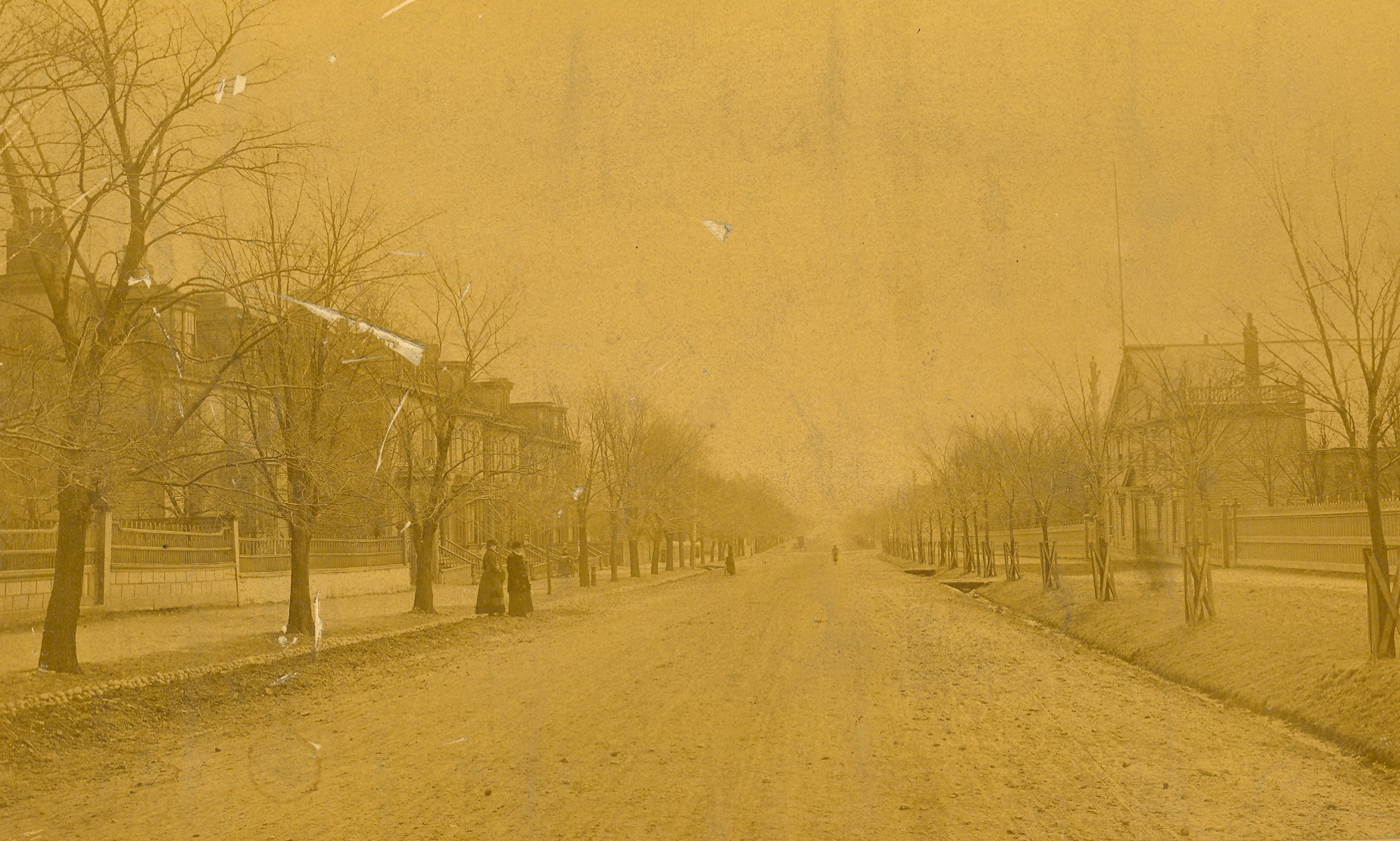 Sepia photo of a wide street in winter.