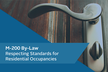 Close up image of a lever handle to a door on the right side of the image and a text box with a blue background and the words M-200 By-Law Respecting Standards for Residential Occupancies on the lower left side