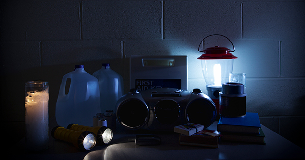 Close up image of a room dimly lit by battery operated lights during a power outage.