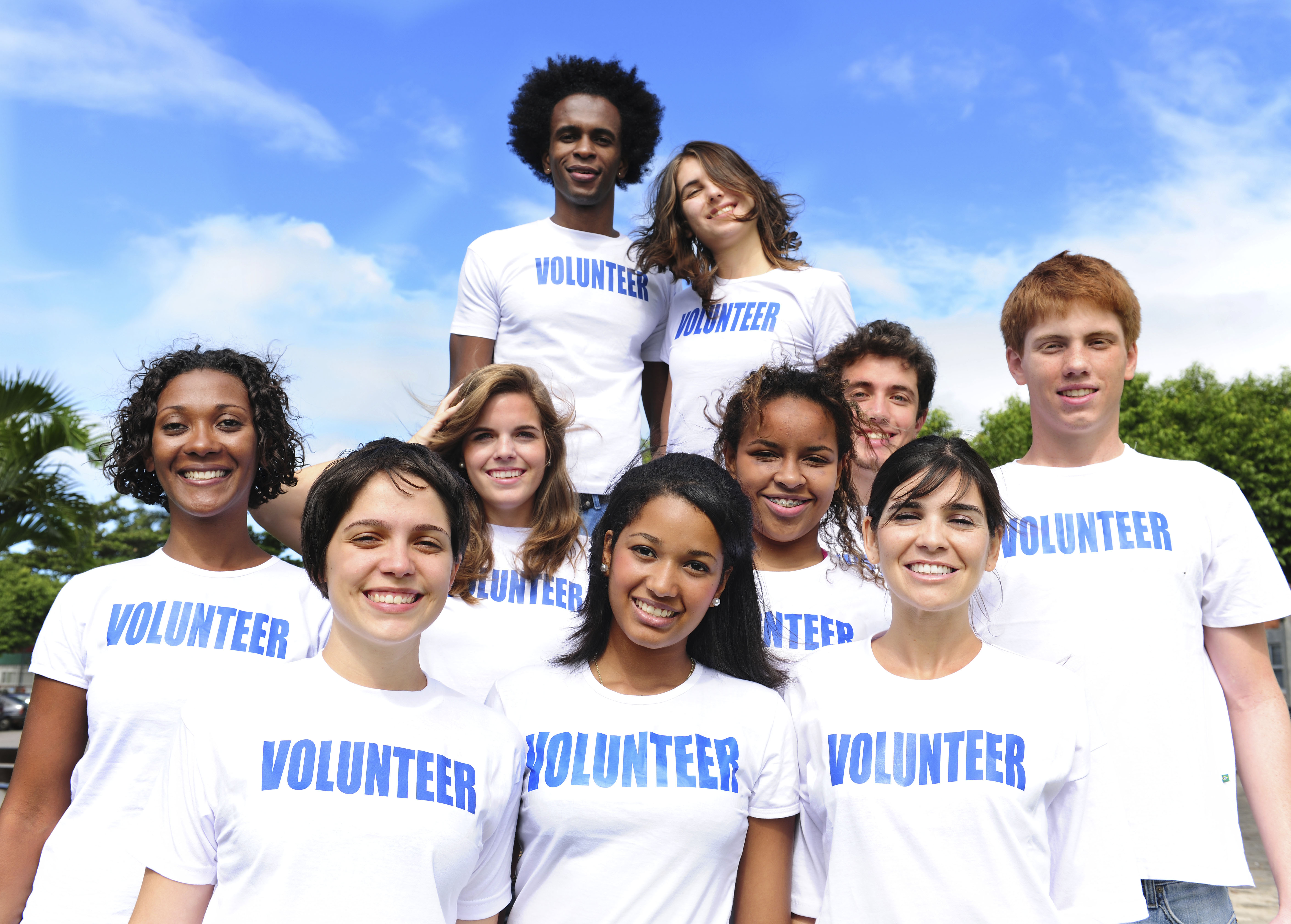 volunteers standing together in white volunteer shirts