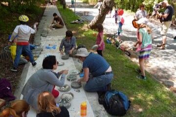 community painting a sidewalk