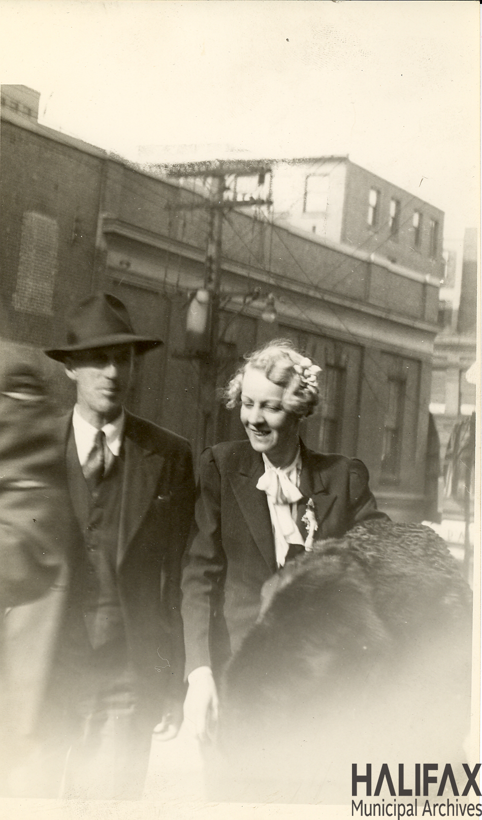 Black and white photograph of couple carrying merchandise