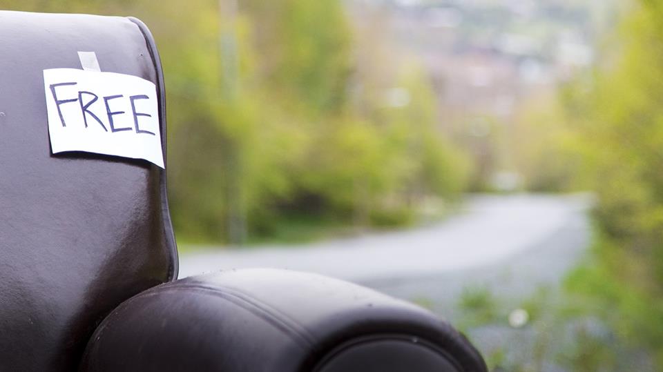 A couch placed curbside labelled "Free"