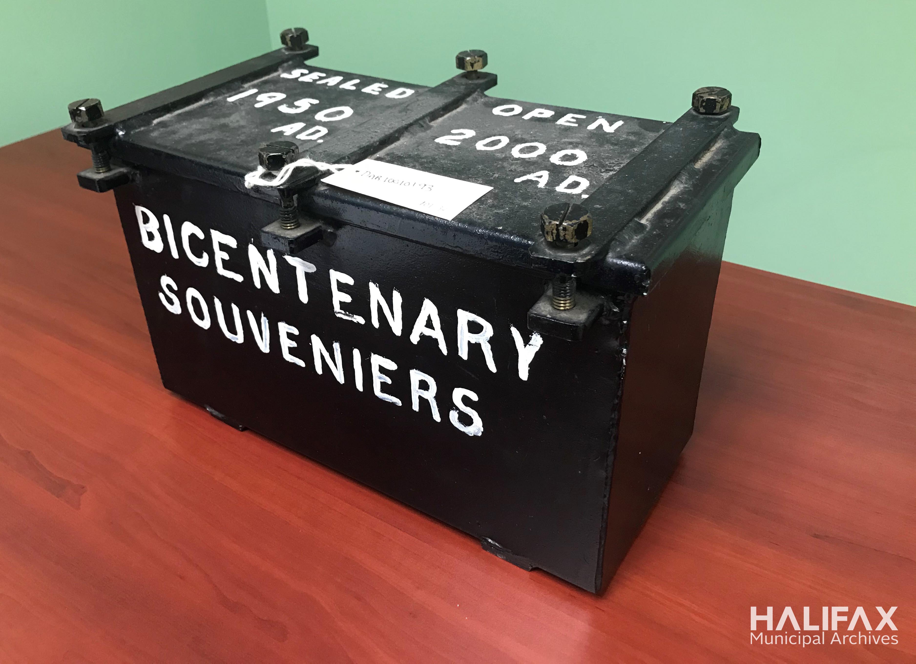 colour photo of a black metal box with the words Sealed 1950A.D. Open 2000A.d. on the lid and "Bicentenary Souvenirs" on the front