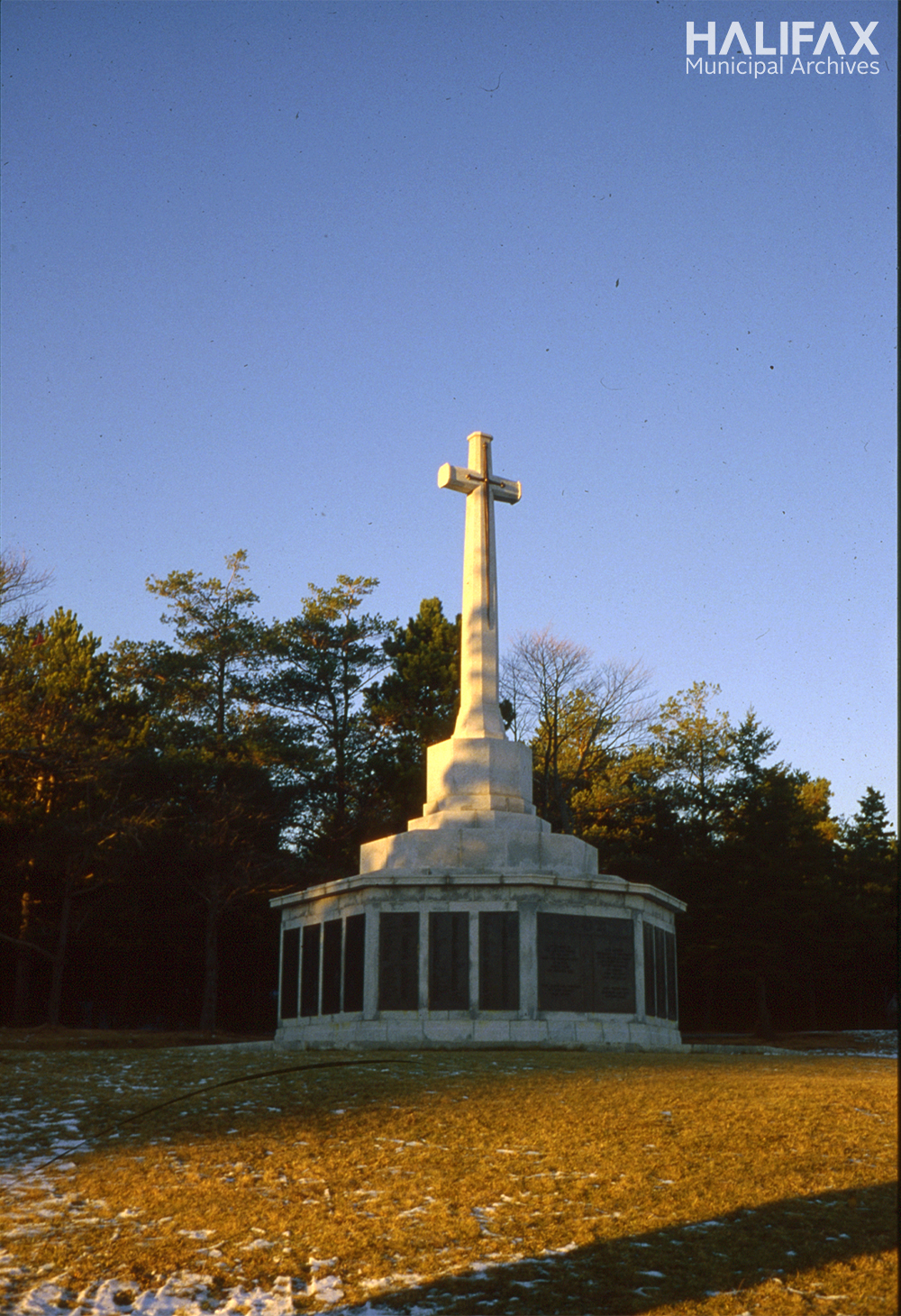colour photo of large stone memorial with cross on top