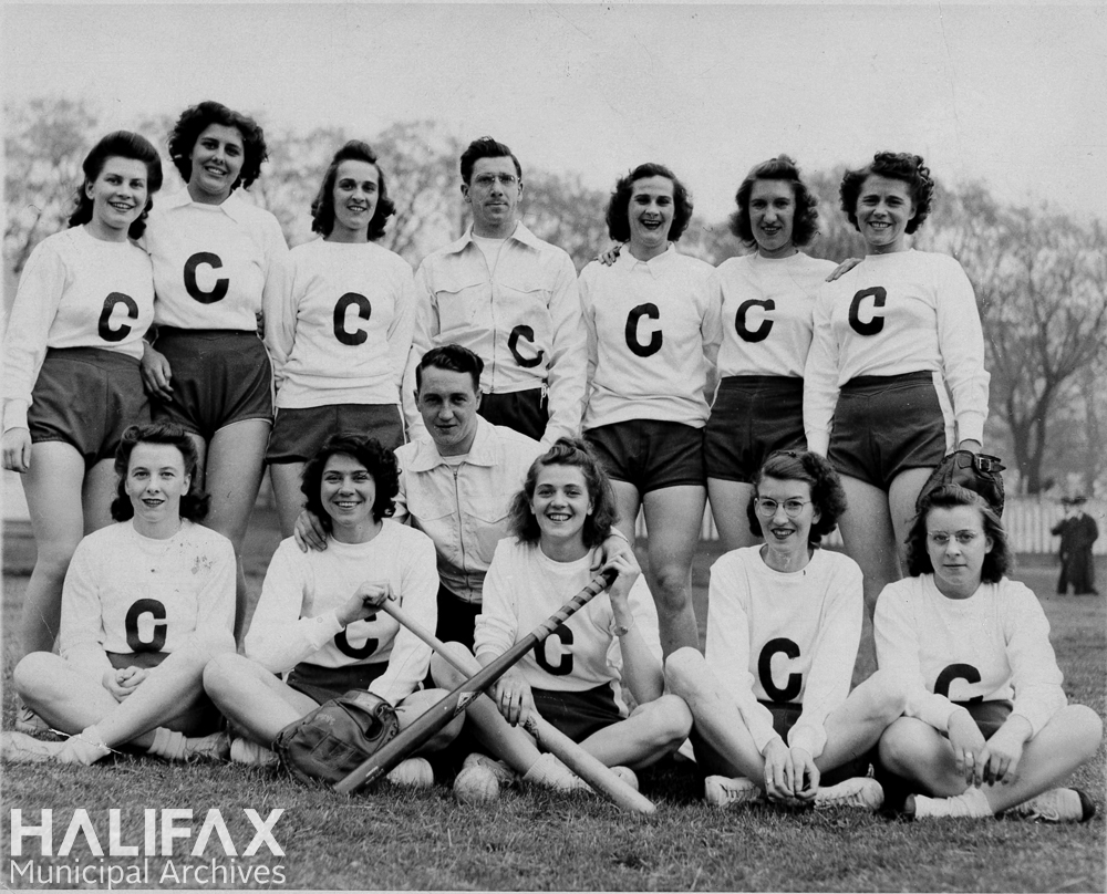 Black and white photograph of a women's softball team posed outdoors