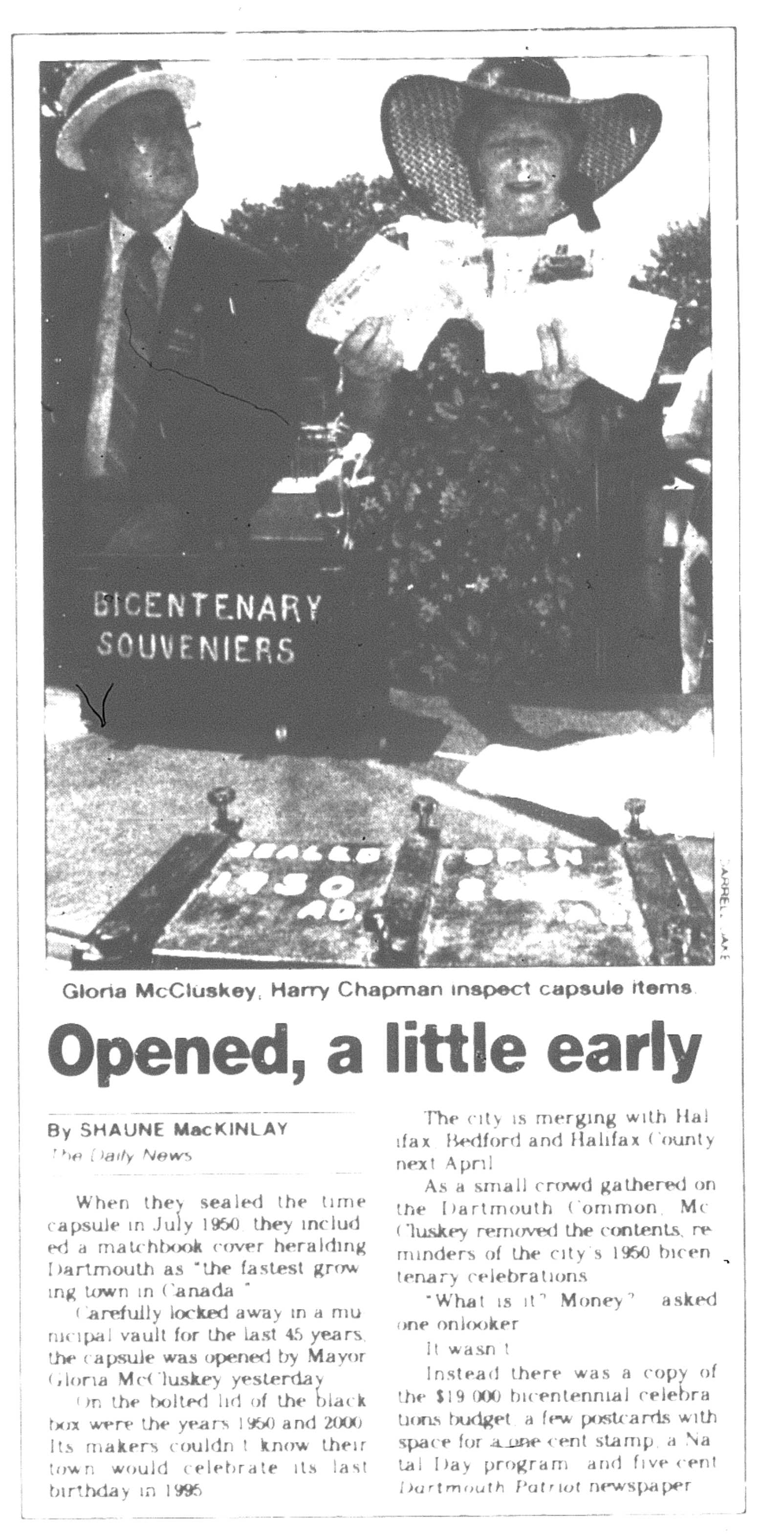 photograph of a newspaper clipping showing a man and woman in front of a box labelled Bicentenary Souvenirs Sealed 1950 AD Open 2000