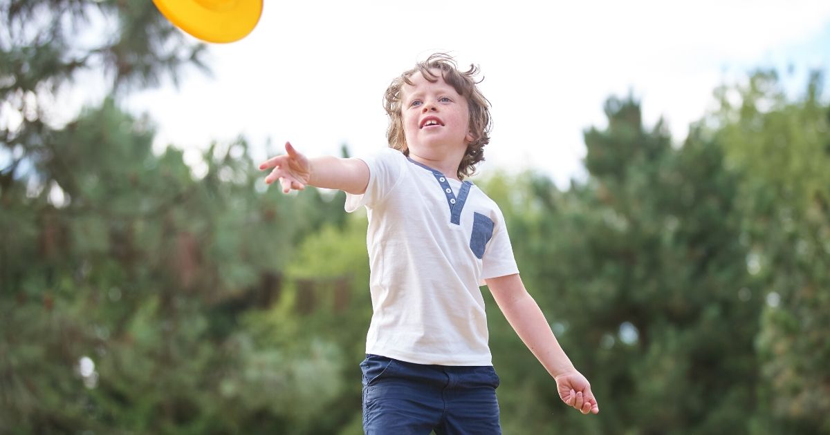 a child throwing a frisbee