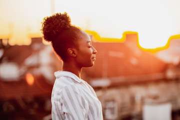 Woman standing at sunrise