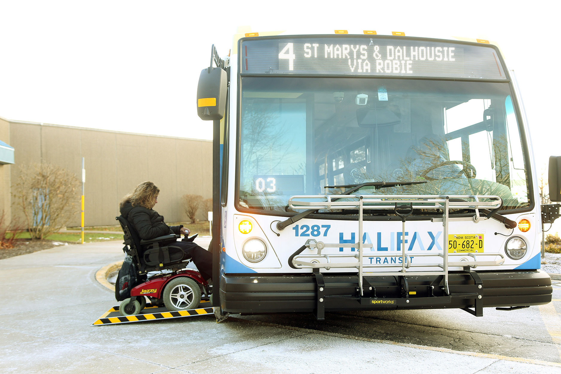 picture of a person on a wheelchair getting on a Halifax Transit bus