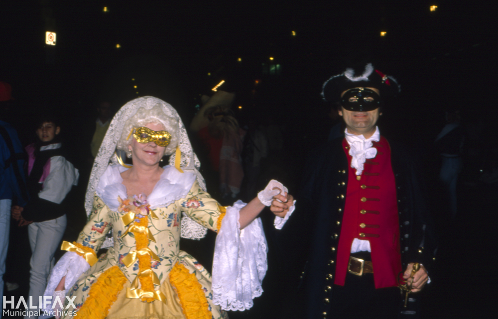 Colour photo of couple in 18th century style costumes.