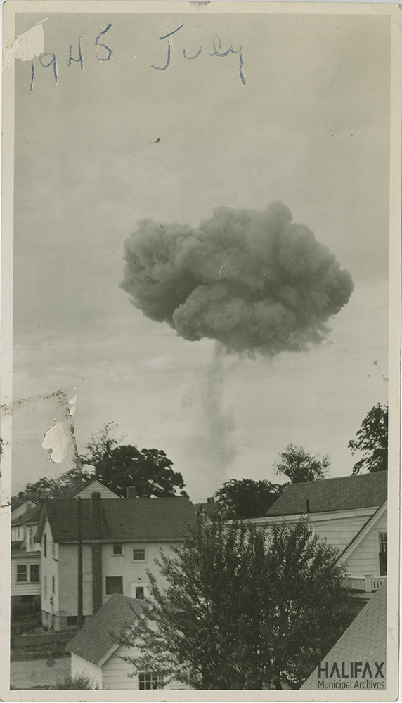 black and white photograph of a mushroom cloud above houses, probably in Dartmouth