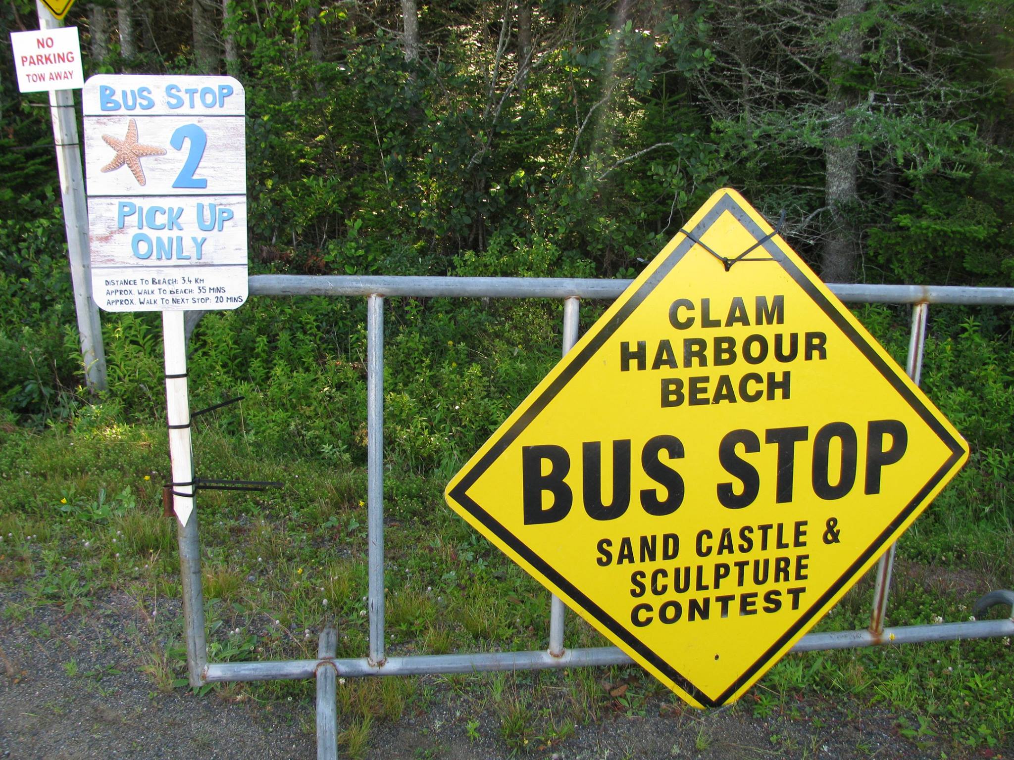 Example of a bus stop station, bright yellow sign on a barricade denoting the shuttle bus spot