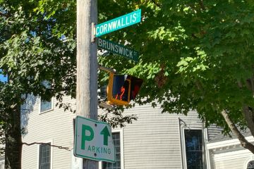 The Cornwallis and Brunswick street signs viewed from the street below