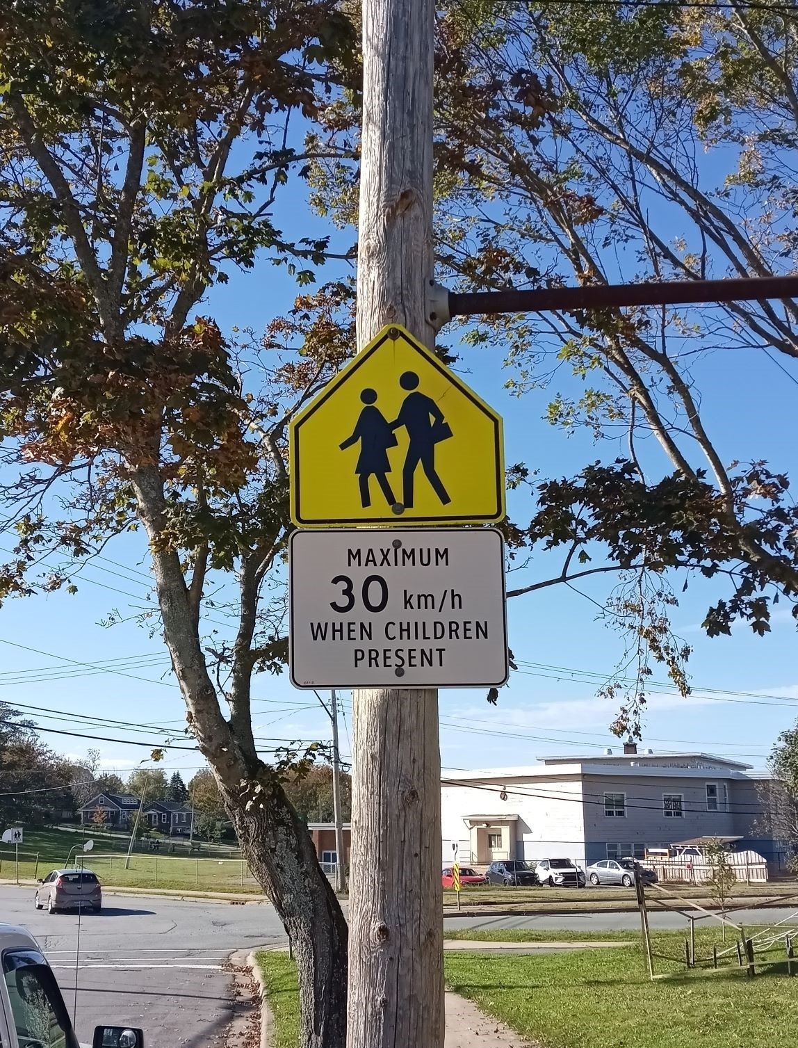 School zone sign. Speed limit is reduced to 30 km per hour when children are present.