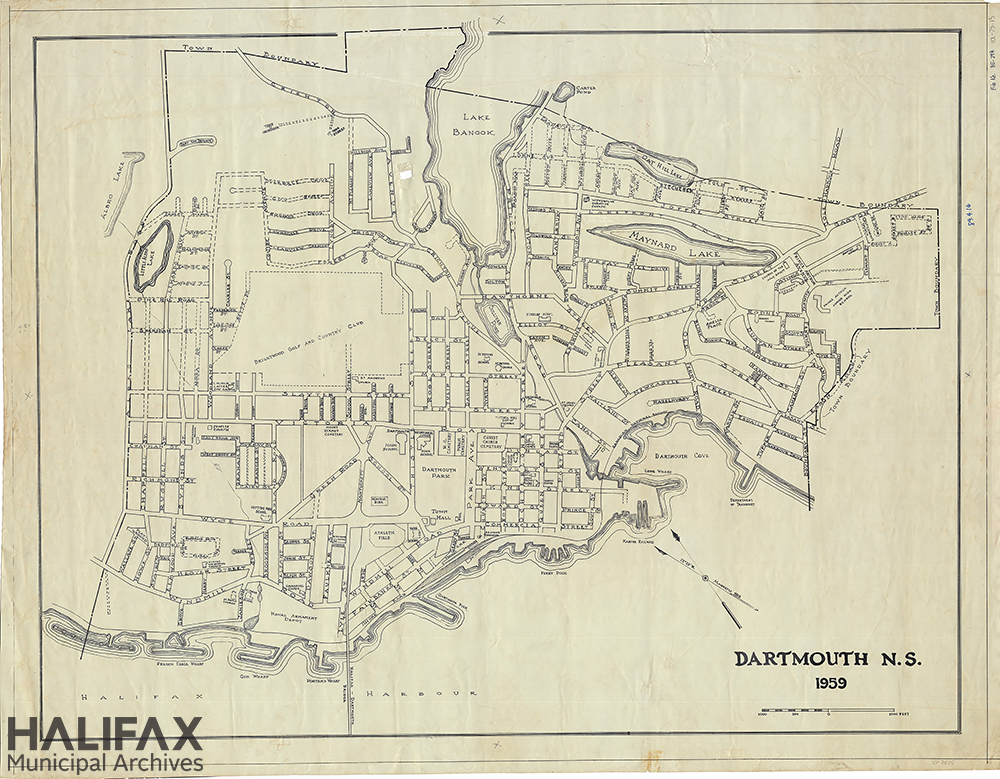 A black and white map of the Town of Dartmouth, showing wharves, streets, lakes, and the Town boundaries. 