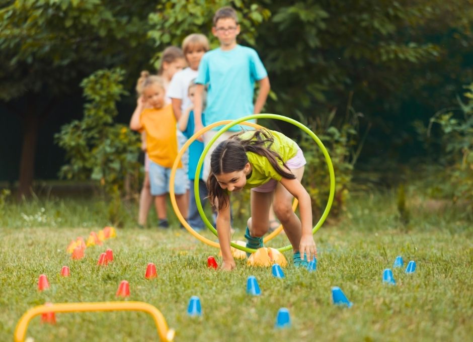 A group of kids playing lawn games in summer
