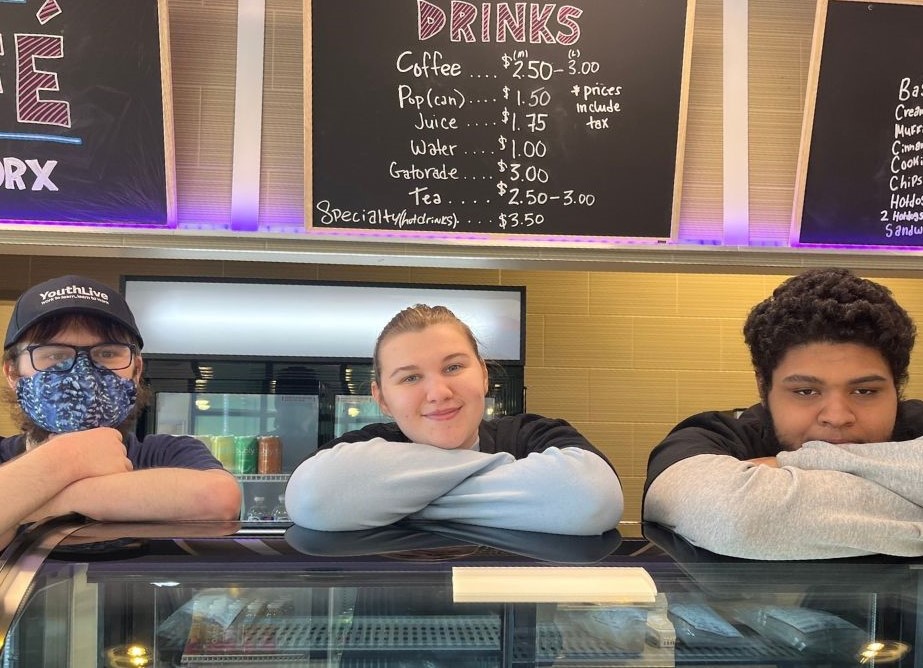 Three Youth Worx participants standing behind the counter at the Youth Worx Cafe