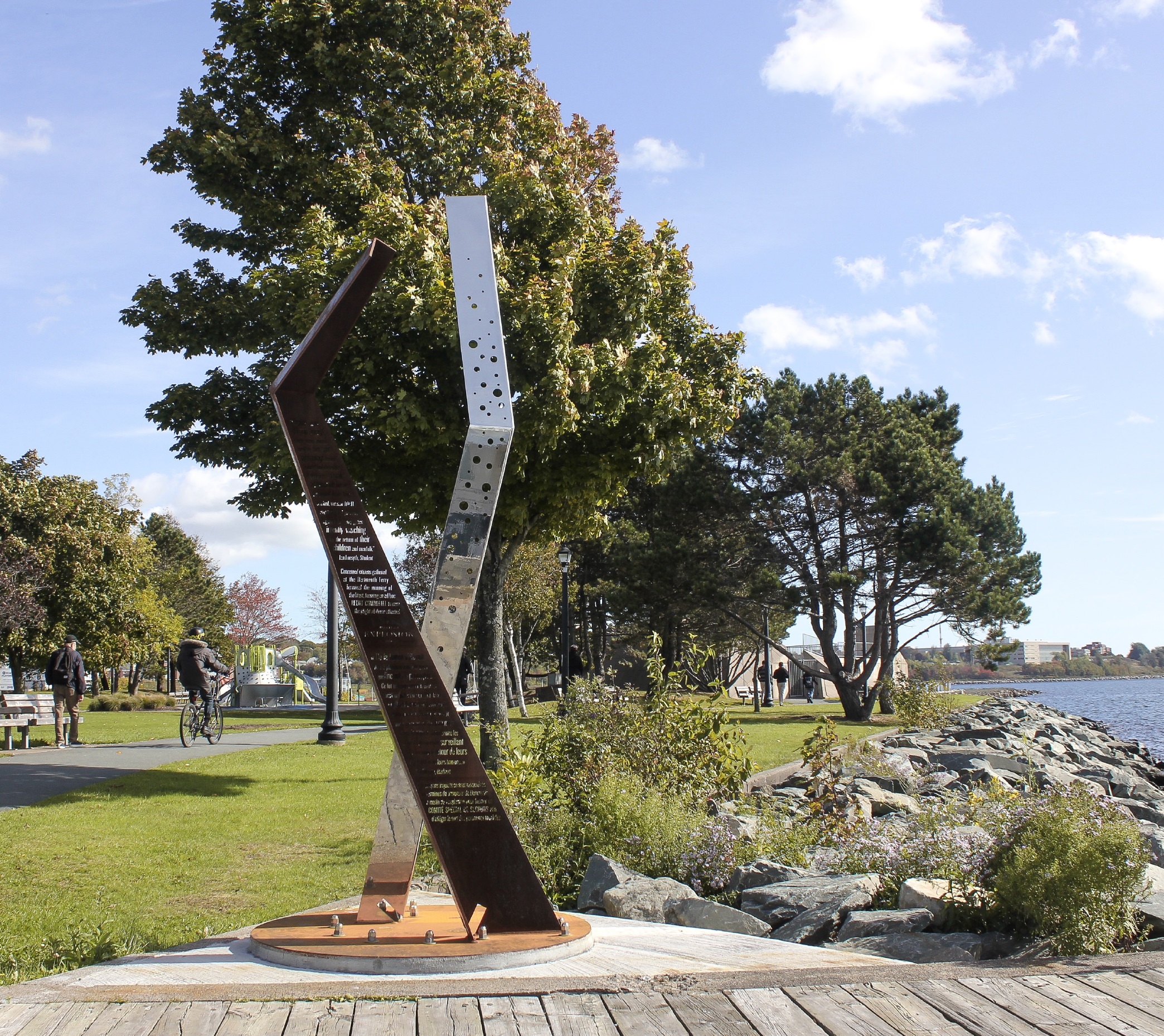 One of the Halifax Explosion Marker Sculptures in a park on a sunny day.