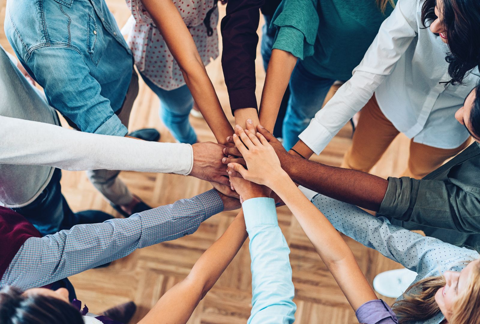 Photo of a diverse team doing a team hand stack