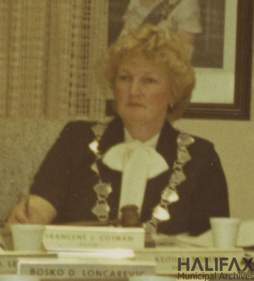 Portrait of woman seated at table wearing mayoral chain of office