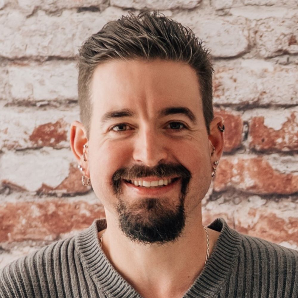 Man with goatee smiling at the camera.