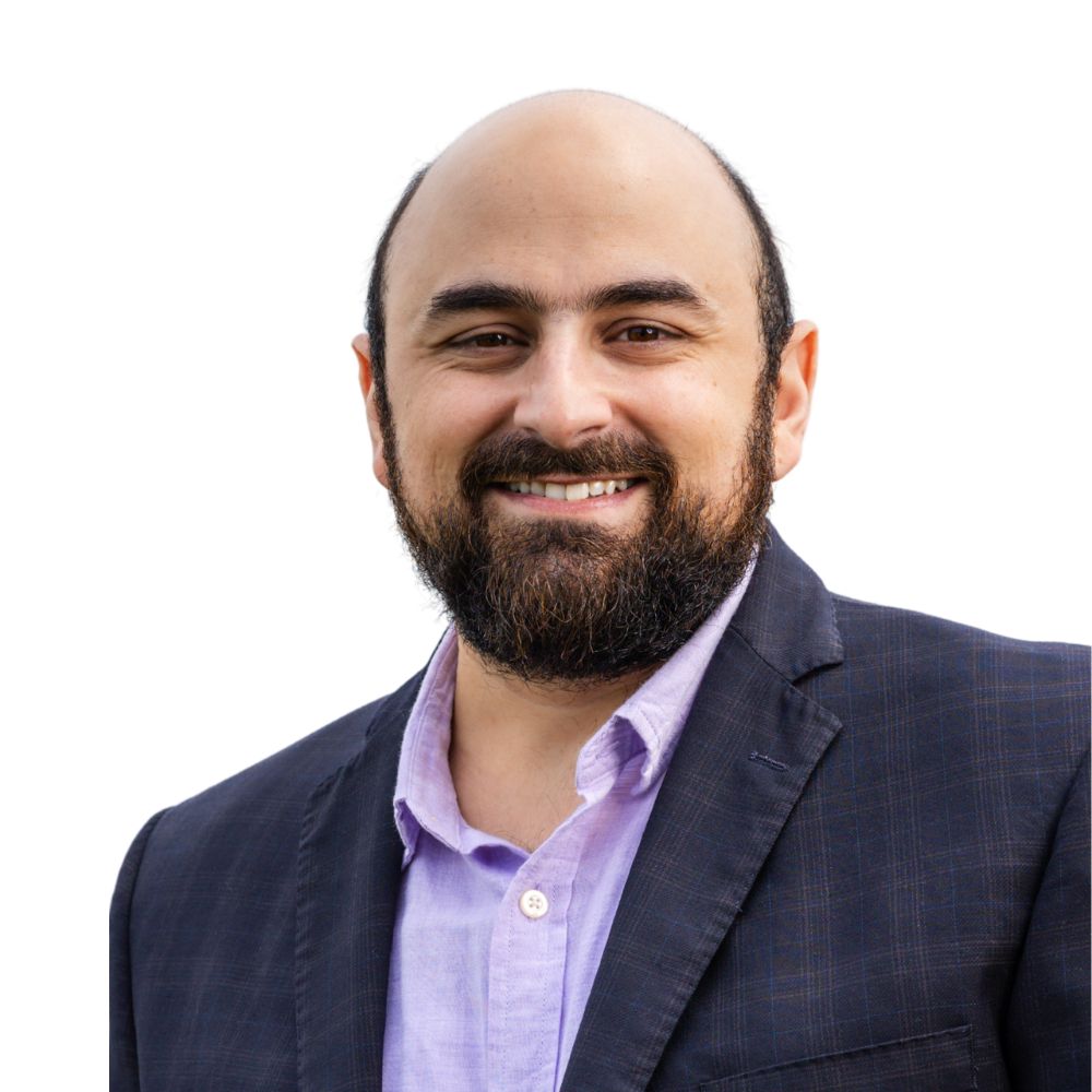 Man with beard smiling.