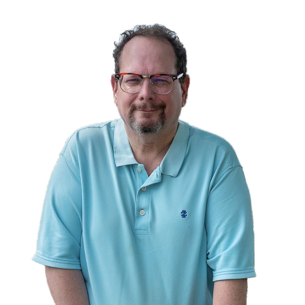 Man in polo shirt smiling at camera.