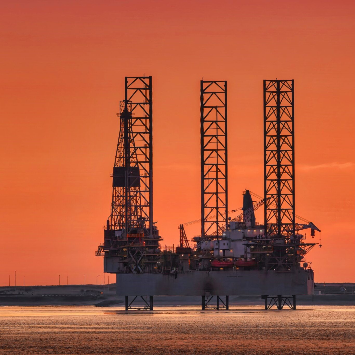 Photo of an oil rig at sunset.