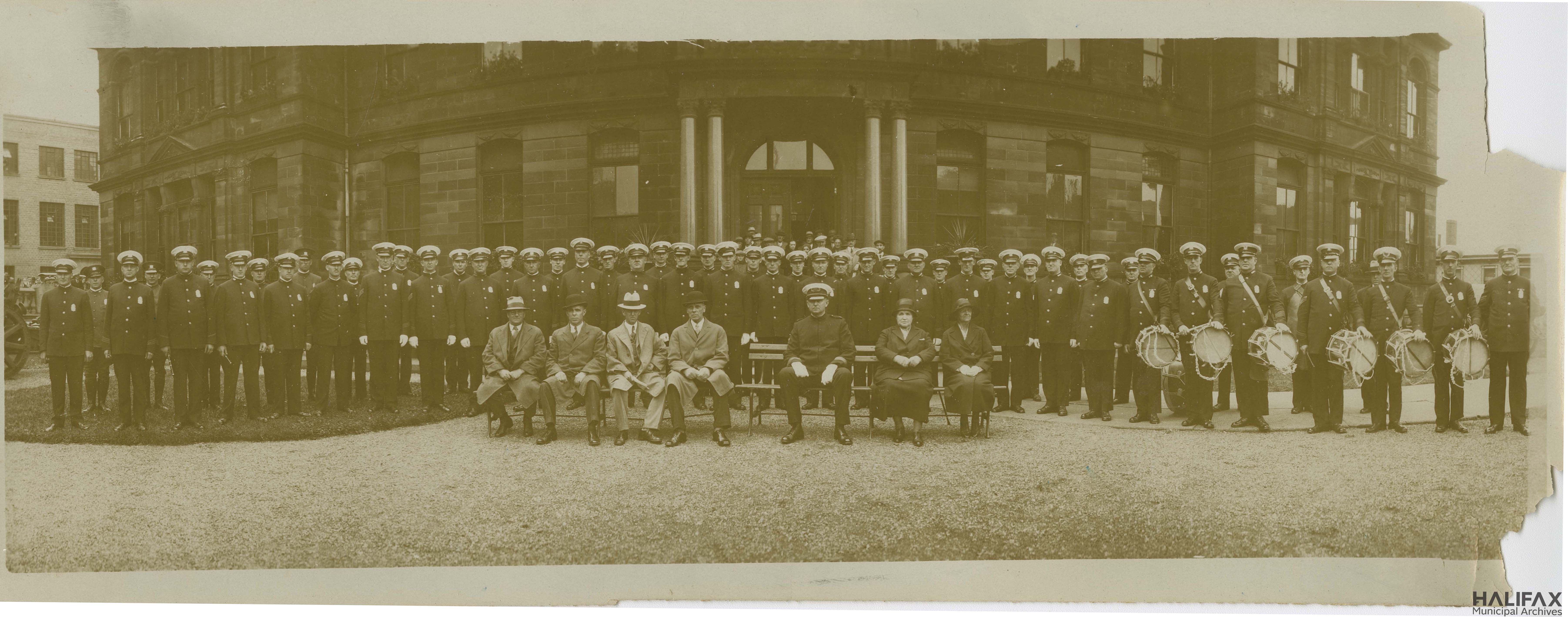 sepia-toned photograph of uniformed officers in front of City Hall