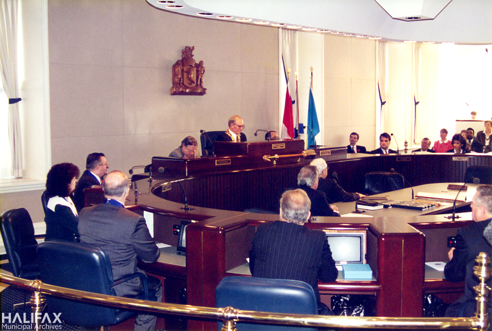 colour photograph of interior of Council Chambers with Mayor Walter Fitzgerald sitting on dais with mace on stand beneath him