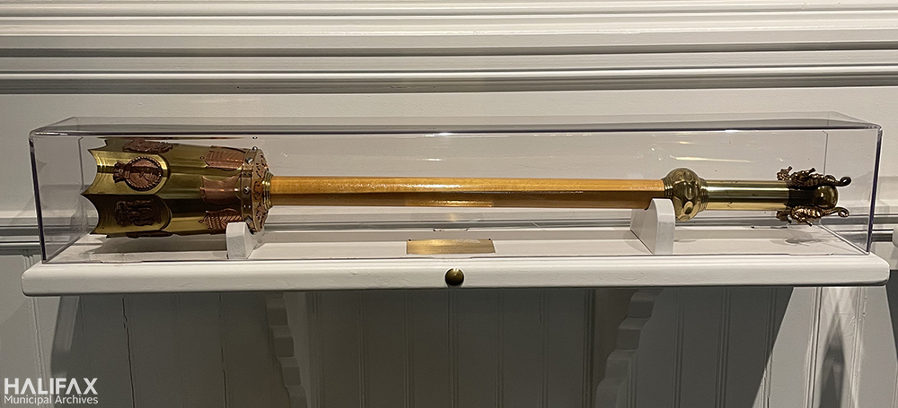 Colour photo of silver mace in glass cabinet