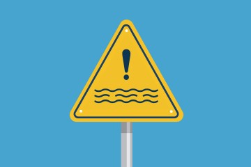 Blue background with triangular warning sign with water and exclamation mark