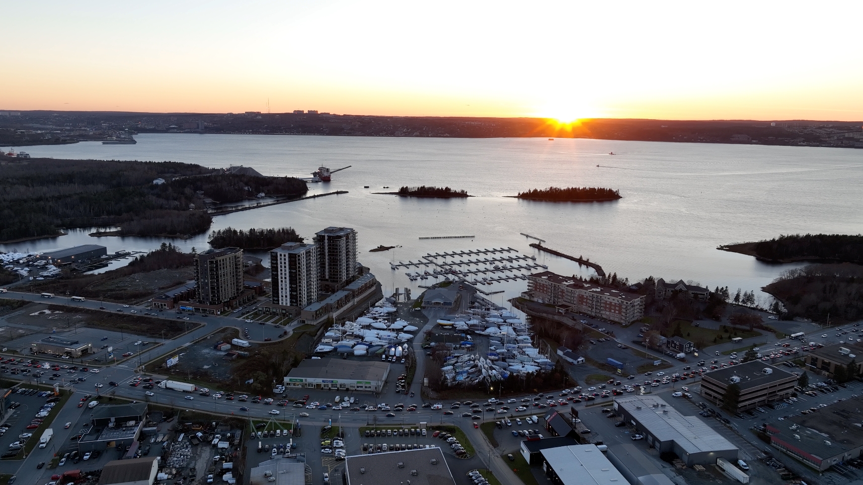 Aerial view of Wyse Road and Akerley Blvd with the sun over the ocean in the background.