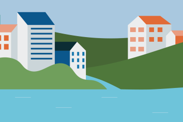 Buildings on hills with a body of water beside them