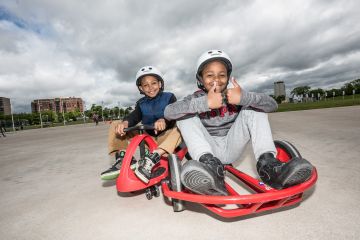 Children using plasma cars at the Emera Oval
