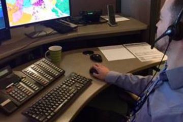 911 call taker at his computer