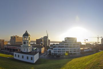 The Halifax Town clock with downtown Halifax on a sunny morning.