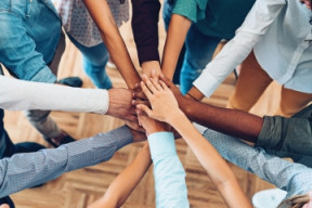 group of people participating in a teambuilding handstack.