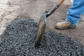 Photo of a pothole being filled.