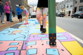 Colourful street mural with kids walking on top (photo by Mo Phung)